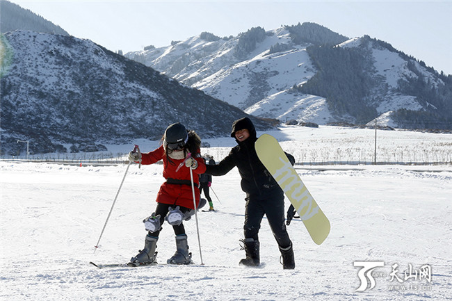 在白云國(guó)際滑雪場(chǎng)內(nèi)，一位初學(xué)者在同伴的攙扶下學(xué)習(xí)滑雪。